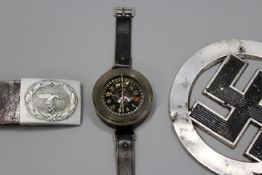 A Third Reich Luftwaffe wrist compass, together with a Luftwaffe belt and buckle and a Third Reich
