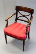 A Sheraton style mahogany armchair with X form back on ring turned tapering legs.