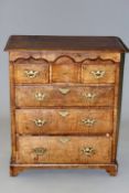 A George III oak and walnut chest of three short and three long drawers on shaped bracket feet, 83cm