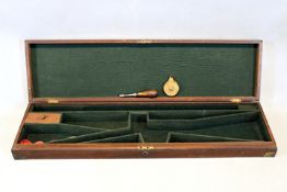 A brass bound mahogany gun case, the green baize lined interior for a gun with 31inch barrels