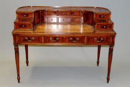 A bespoke mahogany Carlton House desk with shaped arrangement of drawers and cupboard above