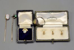 An opal set pin with yellow metal mount together with a further opal set pin, an opal set sterling