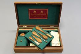 An Holland & Holland Cavalier presentation case of gun cleaning accessories, green baize lined close