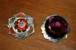 A lot comprising a Scottish silver agate brooch and an Edinburgh hallmarked silver brooch with large