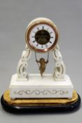 A 19th Century French alabaster cased portico form mantel clock with swinging cherub pendulum, on