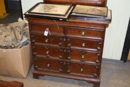An 18th Century oak chest of two short and three long graduated drawers with panelled sides and
