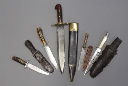 A composite Bowie knife with etched blade and scabbard together with three various horn handled