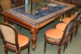 A Victorian mahogany extending dining table on turned carved legs and brass castors, 239 x 120cm