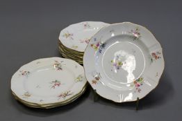 Twenty four Royal Crown Derby service plates decorated with floral sprays, 25.5cm diameter. (24)