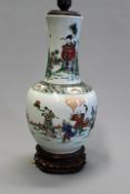 A Chinese famille verte bottle vase with figural decoration, now mounted as a lamp, 34cm high.