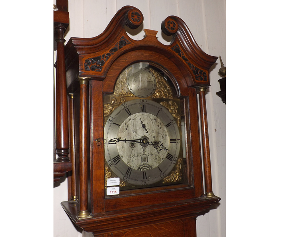 A late 18th Century Oak Long Case Clock, the swan neck pediment with inset later carved panels,