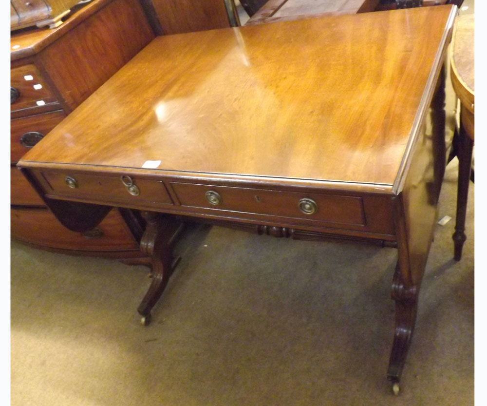 A 19th Century Mahogany Sofa Table, fitted at either end with a drop flap and the frieze fitted on