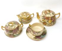 A Satsuma Tea Service, typically decorated in traditional colours with birds and flowering foliage