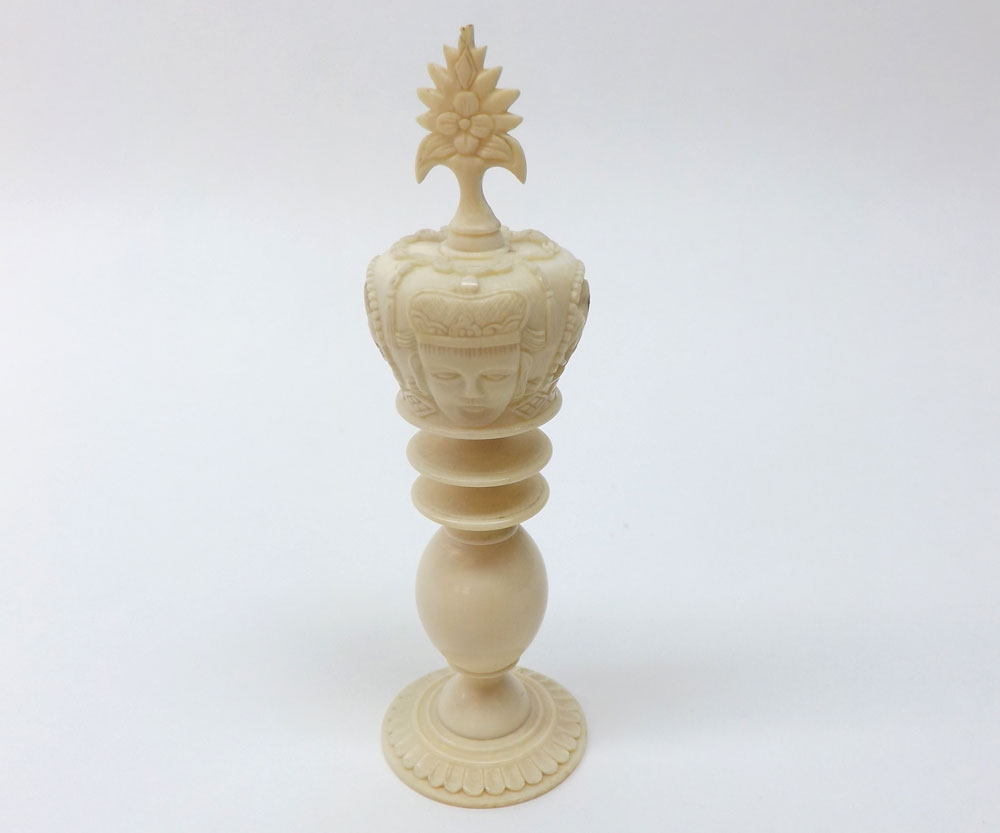 An Oriental Ivory King Chess Piece, a foliate mount over a pierced coronet terminating in a
