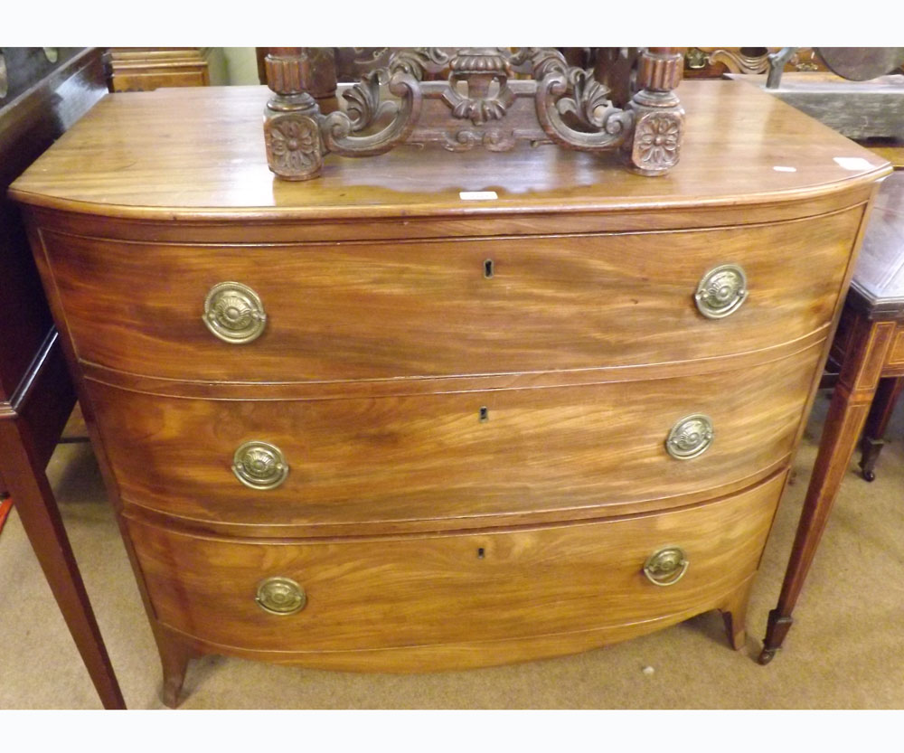 An early 19th Century Mahogany Bow Fronted Chest of three full width graduated drawers on splay