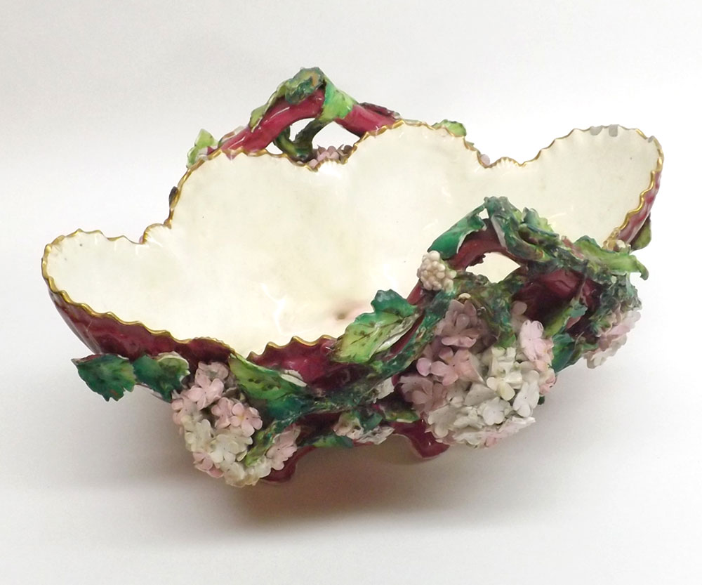 A 19th Century Porcelain Table Basket, decorated with extensive coloured floral encrustations and