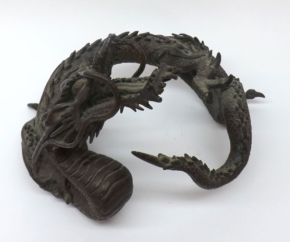 An Oriental Bronze Model of a coiled Dragon, 6? high