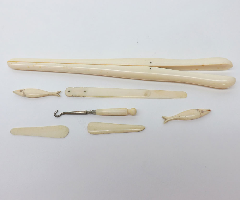 A mixed lot: A pair of Ivory Glove Stretchers, various small carved Ivory Models of Fish, etc