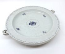 A Chinese circular Warming Dish, the centre painted in under glazed blue with spray of foliage with