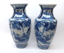 A pair of blue Imari baluster Vases typically decorated in under glazed blue with panels of scenes