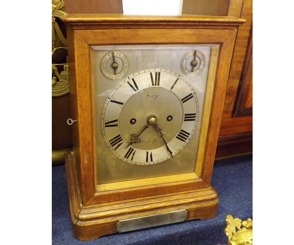 An early 20th Century Oak cased Mantel Clock, the rectangular silvered dial with slow/fast and