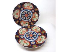 A pair of Imari circular large Plates with hipped rims and the centres painted in colours with