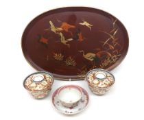 A Chinese lacquered oval Tray decorated with flying cranes and foliage, a pair of circular covered