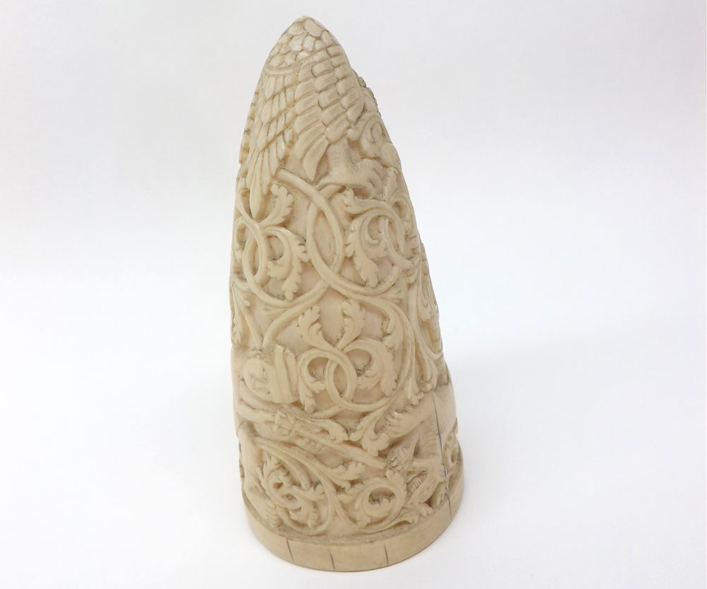 An Oriental carved Ivory Prism, ornately carved with hunters and their quarry and scrolls, etc,