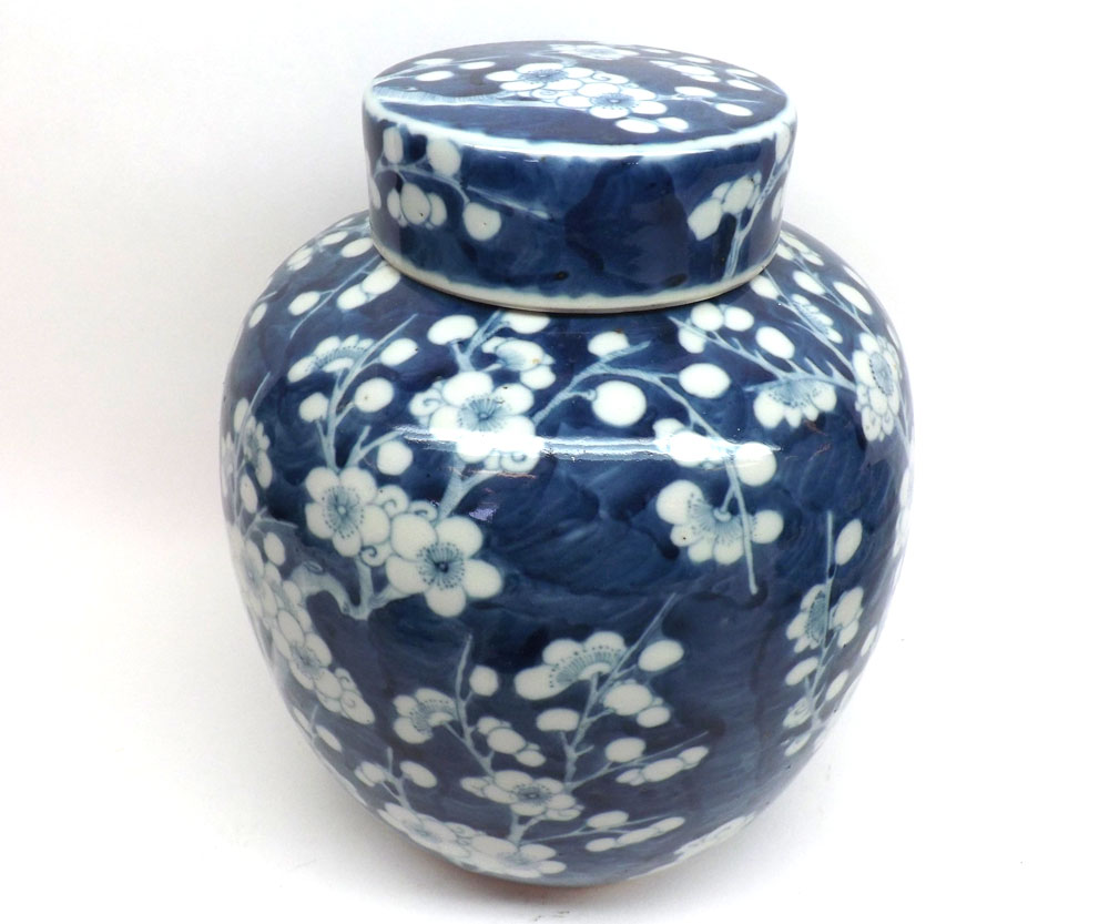 An Oriental large covered Jar decorated in under glazed blue with a prunus blossom design, 10? high