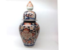 A 19th Century Japanese Imari covered Jar or tapering baluster form, typically painted in