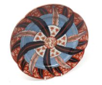 An Imari circular Plate, unusually decorated with a radiating rosette design, within a
