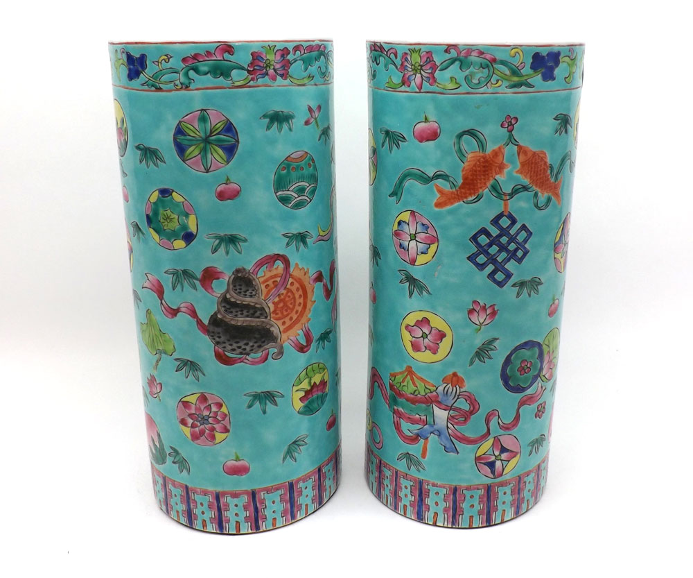 A pair of Chinese cylinder Vases, painted in colours with fish, objects, foliage, etc, 11" high