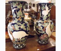 A pair of 20th Century European large baluster Vases decorated in the Oriental manner with flying
