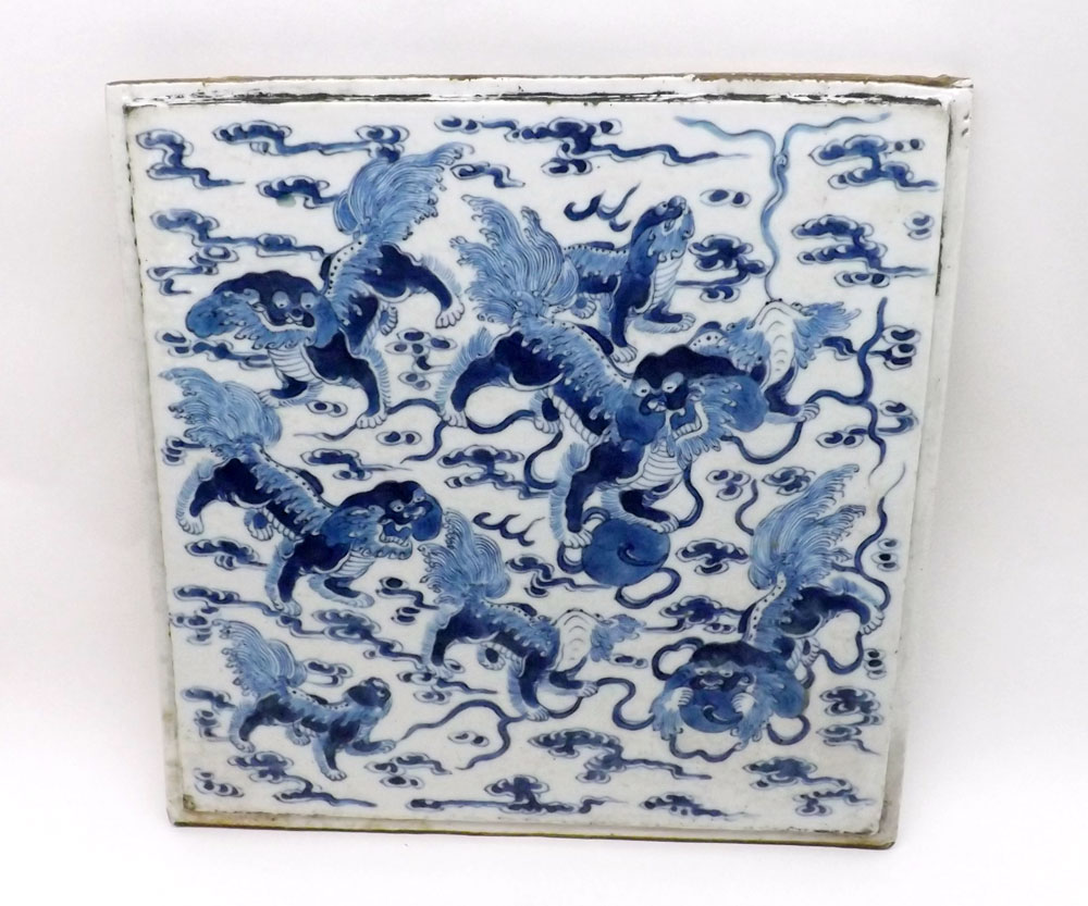 A Chinese large Tile, decorated in under glazed blue with Kaolin amongst smoke clouds, 19th