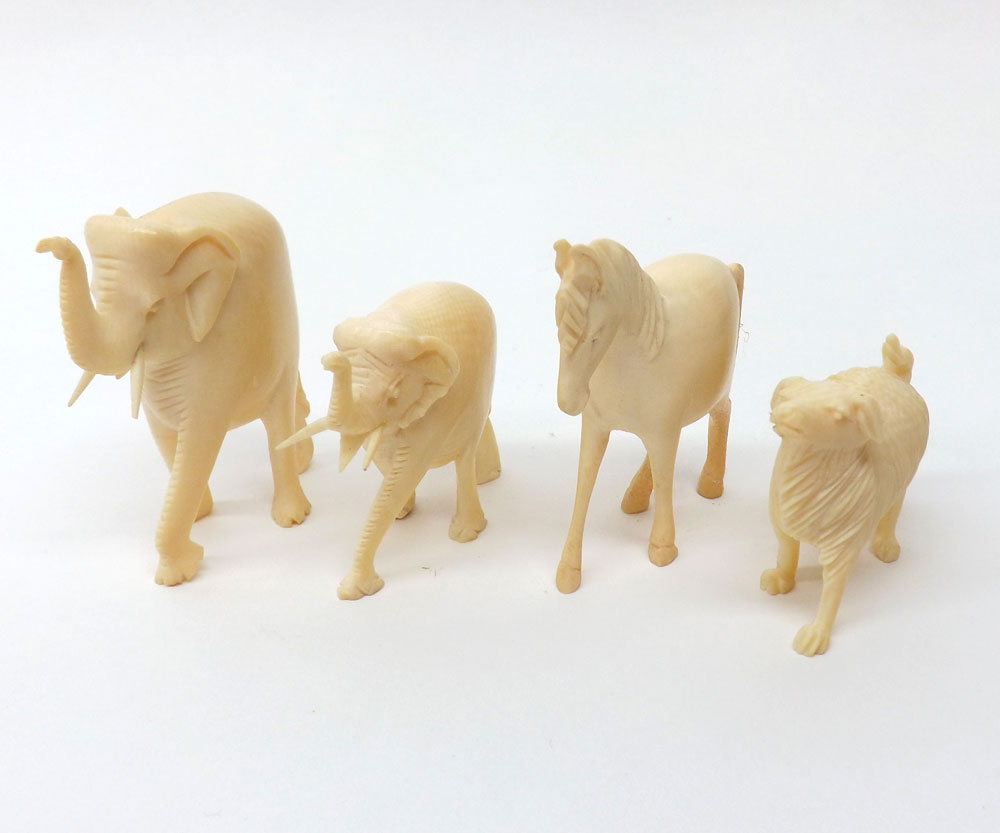 A collection of four carved Ivory Animals including two elephants, horse and sheep, various sizes