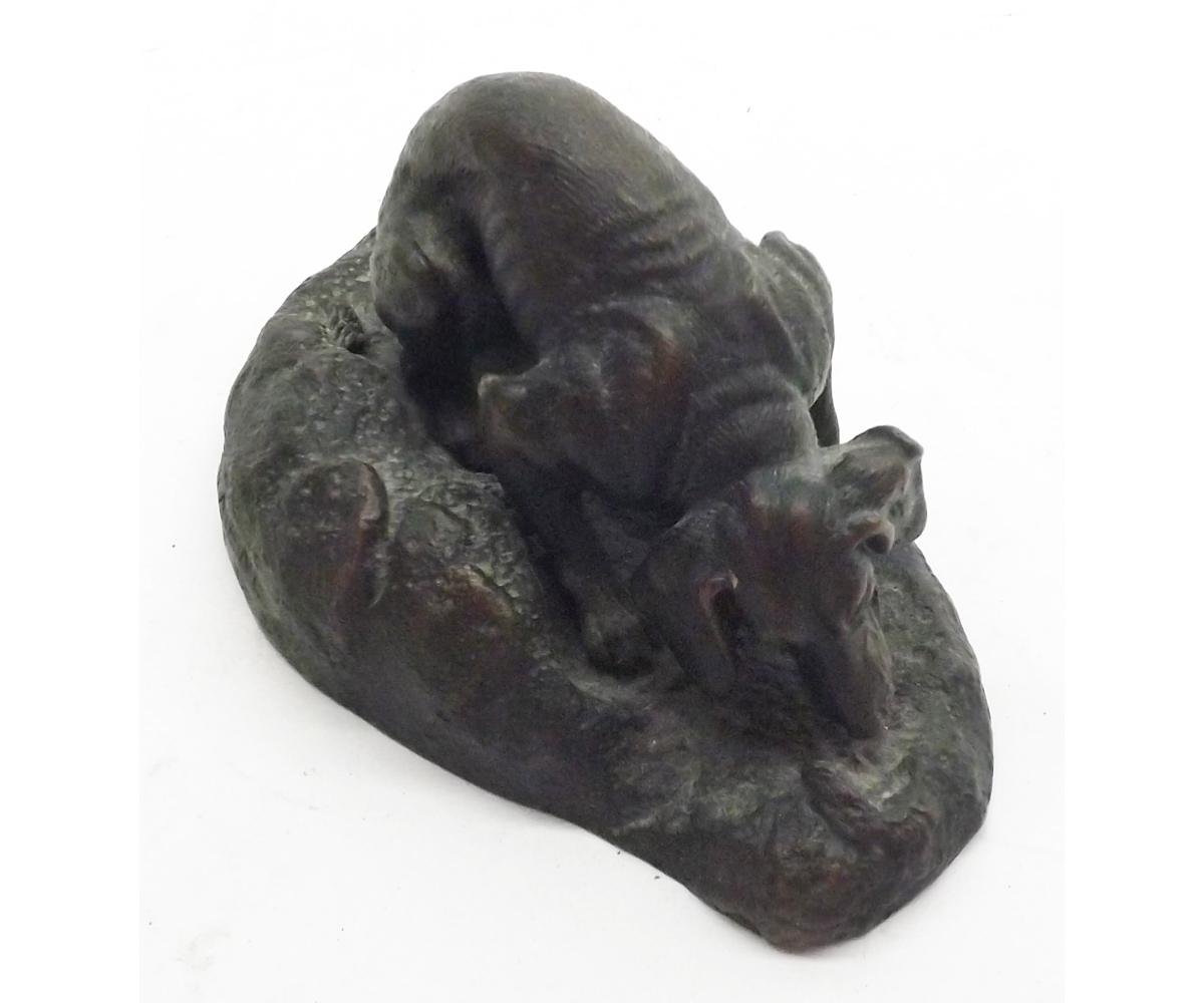 A small Bronze Model of a seated Dog, marked to base ?Mene?, 4? long