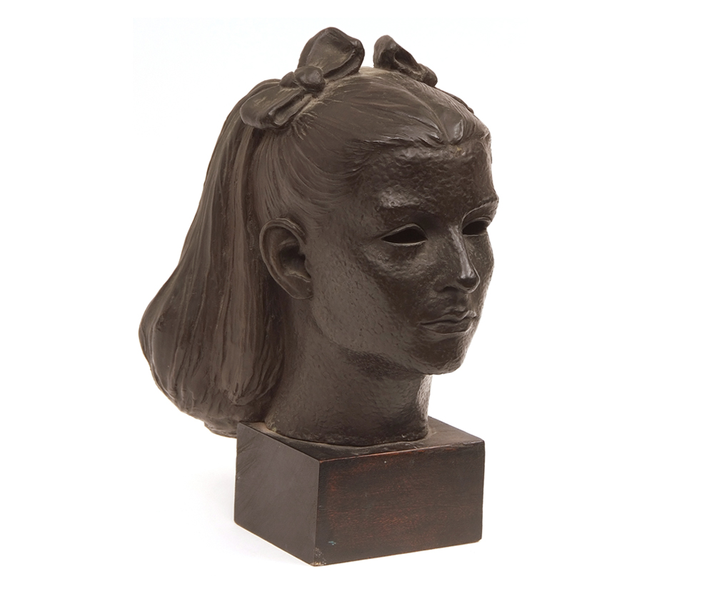 A 20th Century Bronze Bust of a Young Girl with bows in her hair, raised on a square wooden plinth