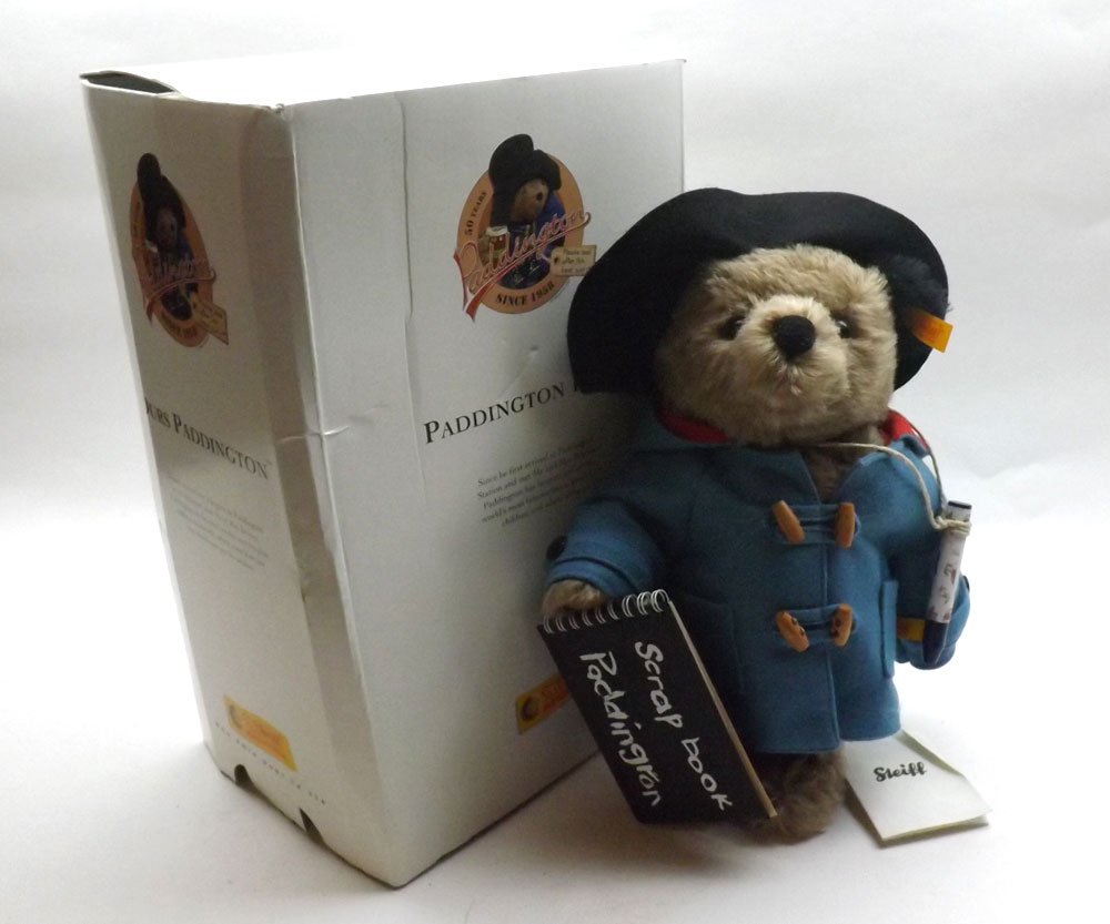 A modern Steiff Paddington Bear, mohair bear dressed in blue felt duffle coat with black felt hat