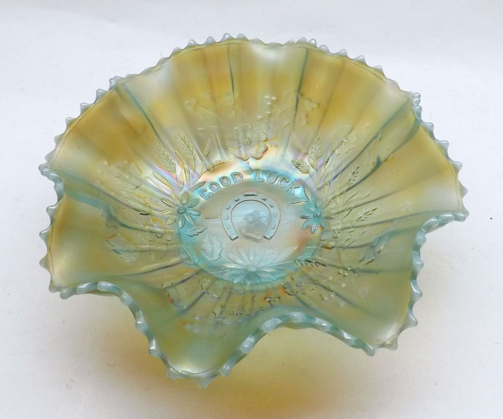 A Frilled Carnival Glass Dish with lustre finished, decorated with foliage and central horseshoe