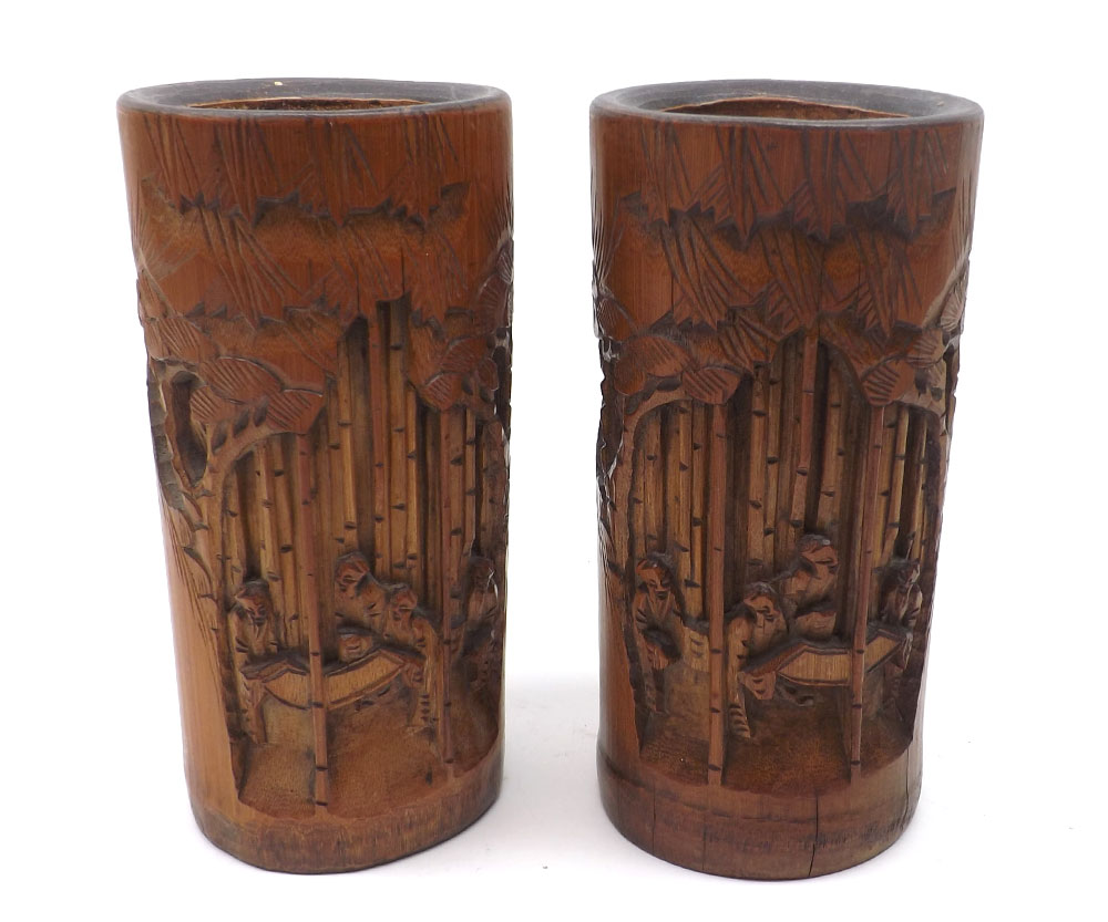 A pair of Oriental Treen Cylinder Vases, the outer bodies carved with figures and palm trees, 7 ½?