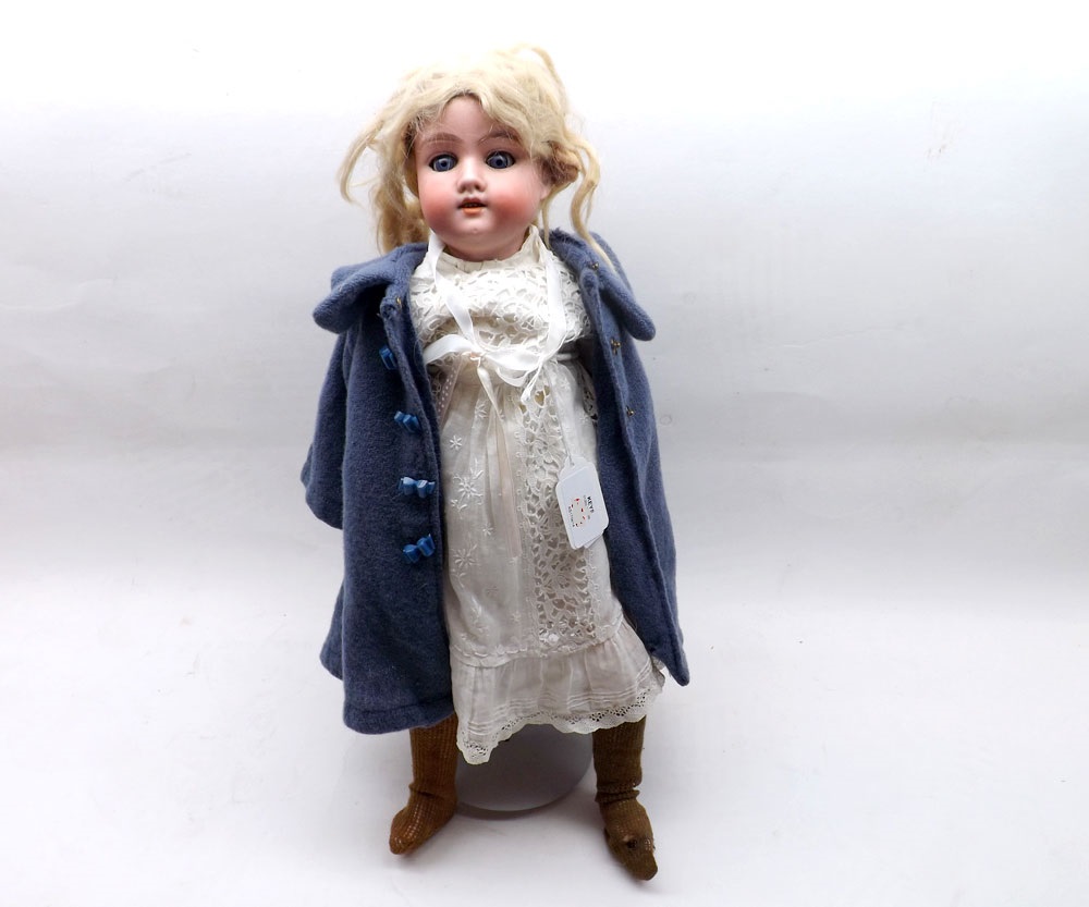 An early 20th Century German Bisque Head Doll, with weighted blue sleep glass eyes, painted lashes