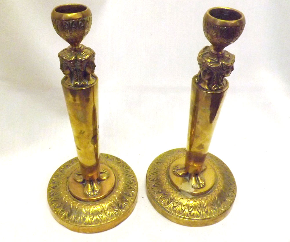 A pair of Heavy Victorian Brass Candlesticks with moulded sconces over caryatid supports,