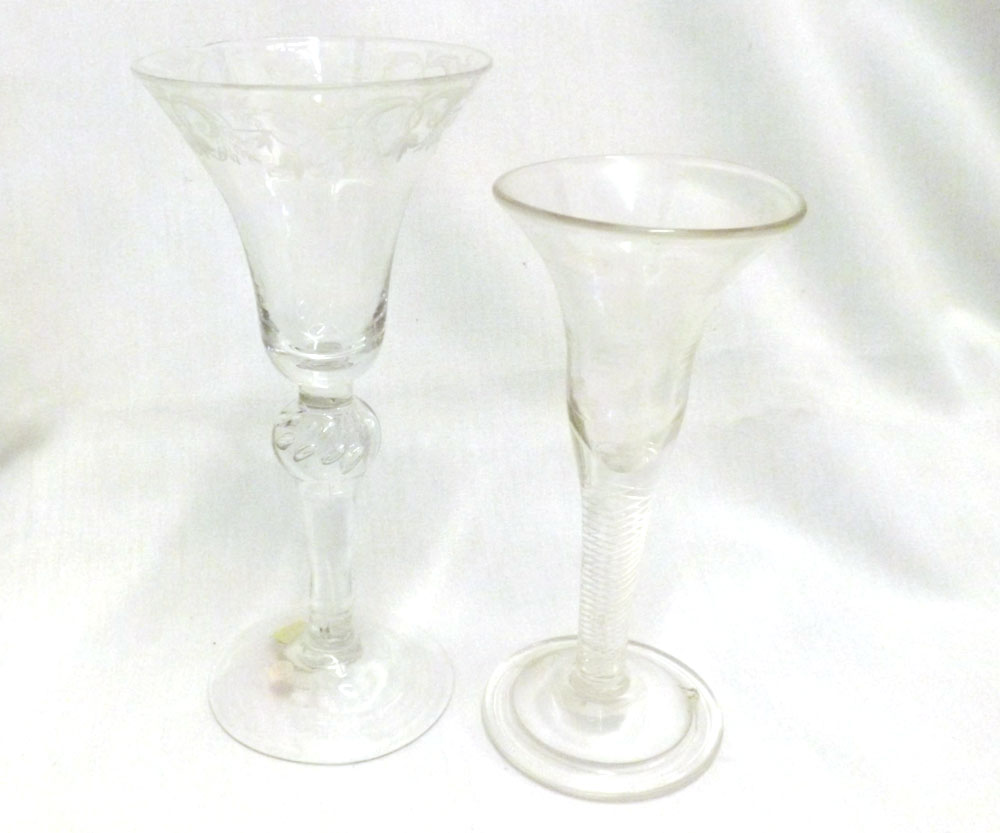 Two 18th Century style Wine Glasses, one with engraved rim on an air twist ballustroid stem, (rim