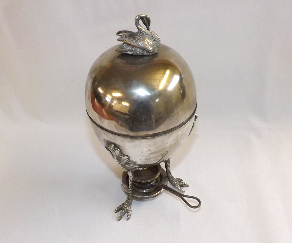An unusual Mappin & Webb Silver Plated Egg Coddler, with integral spirit burner, raised on three