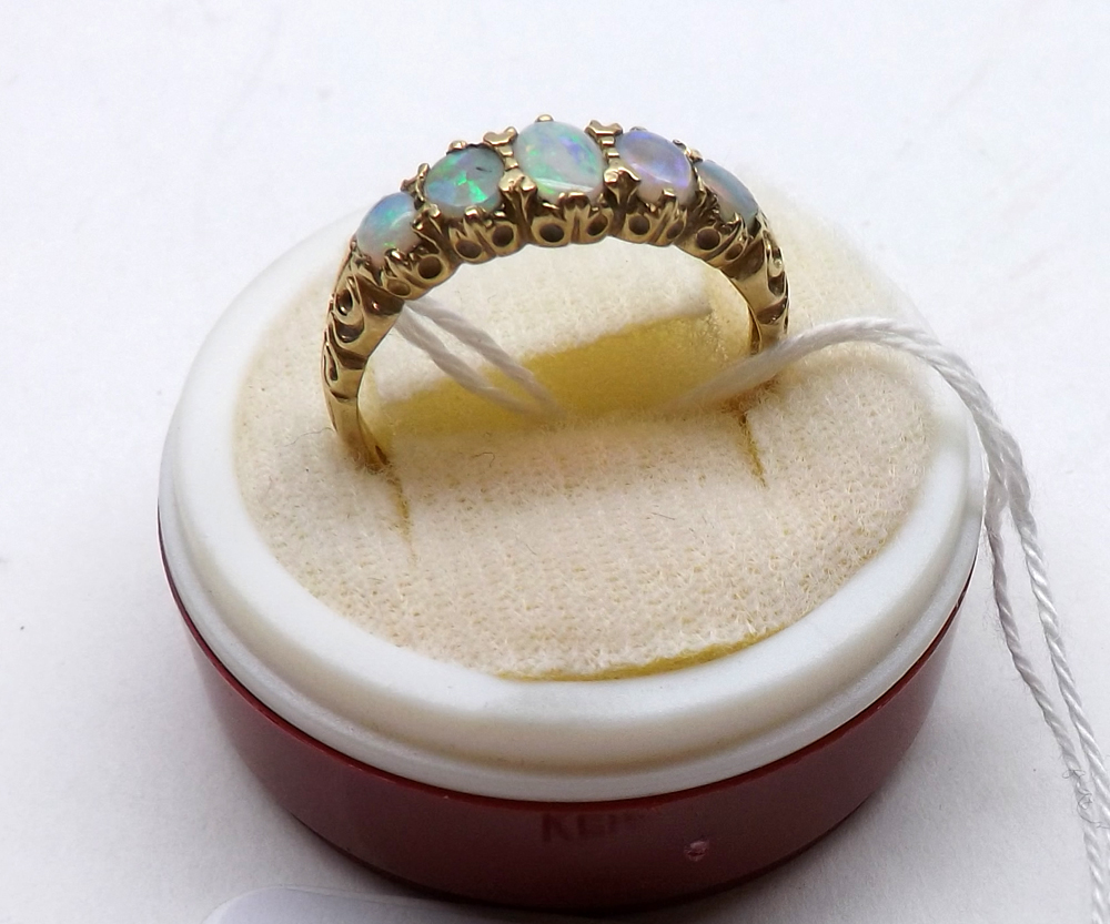 A hallmarked 9ct Gold five Graduated Opal Ring with carved setting