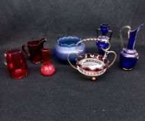 A Mixed Lot comprising: two small Cranberry Glass Jugs; a small Sweetmeat Basket and other decorated