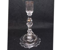 A late 18th Century Facet Cut Clear Glass Candlestick, raised on a spreading base, 9” high