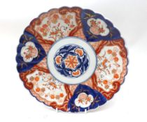 A Japanese Imari Plate with crimped rim and typically decorated in traditional colours with a
