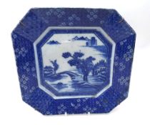 A Chinese Octagonal Plate, the centre decorated with a river scene, within a geometric foliate