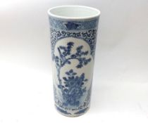 A Chinese Cylinder Vase decorated throughout in underglaze blue with panels of scenes of exotic